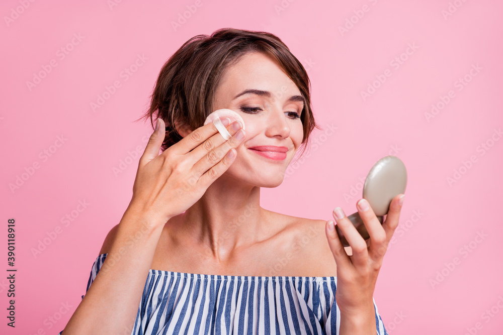 Closeup photo portrait of pretty girl blushing cheeks looking at mirror wearing bob hairstyle isolated on pastel pink color background Closeup photo portrait of pretty girl blushing cheeks looking at mirror wearing bob hairstyle isolated on pastel pink color background