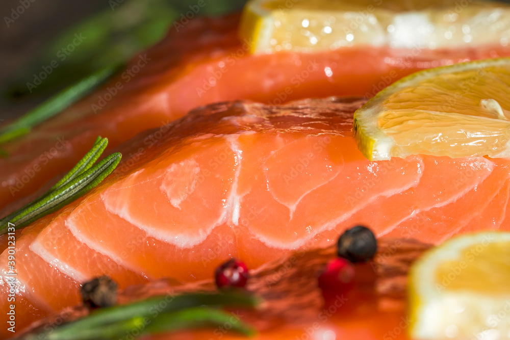 fresh trout fillet, Close up raw and fresh salmon. Fresh raw fish fillet with cooking ingredients, herbs and lemon on black background