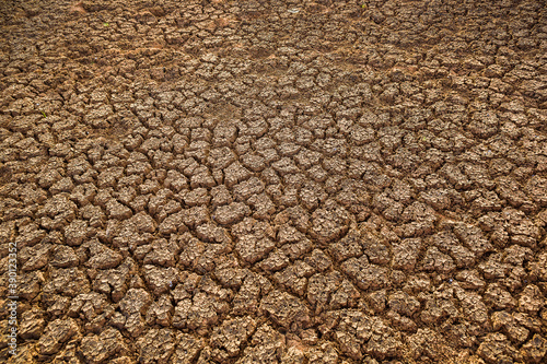 Ground cracks drought, dry cracked land background. Crisis environment concept.