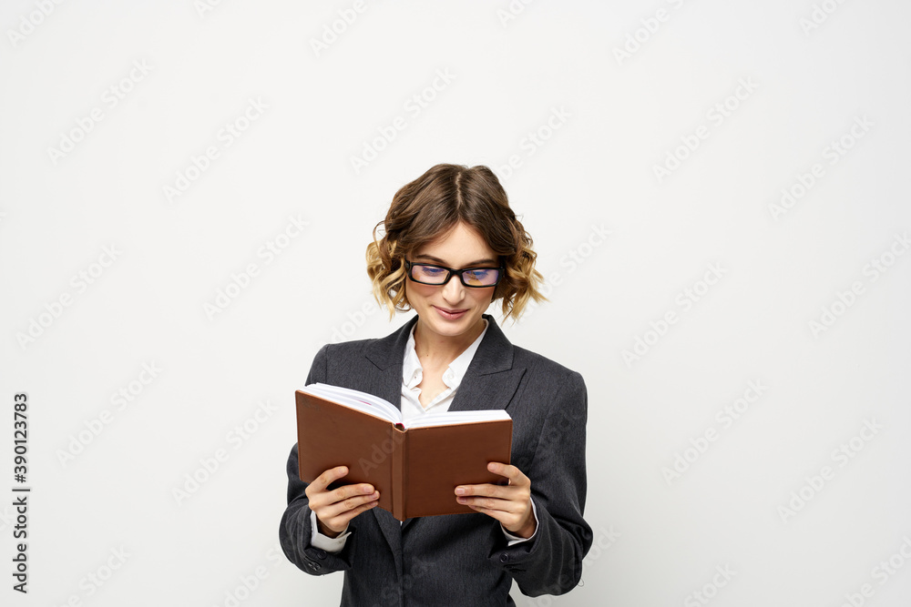 Business woman with notepad and glasses work light background cropped view of suit model. Business woman with notepad and glasses work light background cropped view of suit model.