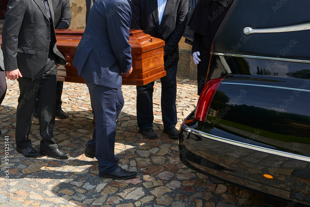 Group of survivors carries a coffin out of the church after a funeral mass - obrazy, fototapety, plakaty 