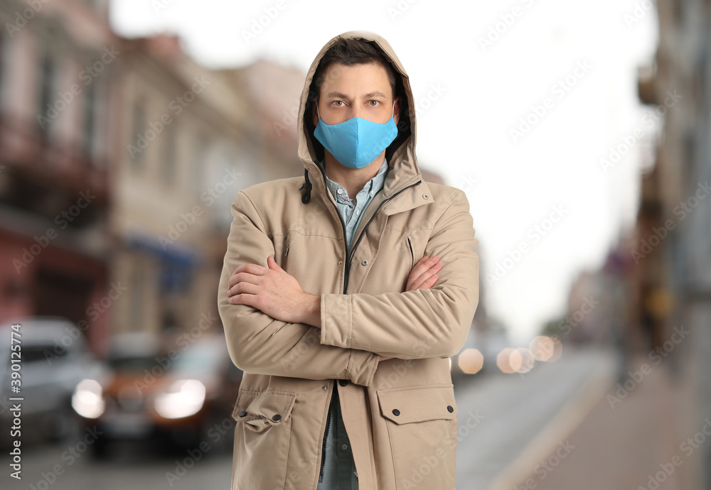 Male tourist in protective mask in old city. Concept of traveling during coronavirus epidemic Male tourist in protective mask in old city. Concept of traveling during coronavirus epidemic