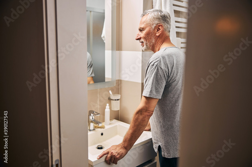 Senior citizen preparing to do his morning bathroom routine