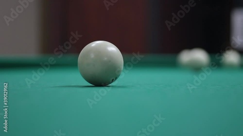Wallpaper Mural Game of billiards. White billiard balls roll on the table. Sports entertainment in the bar. Simple background with a pool table. Balls hitting and moving. Torontodigital.ca