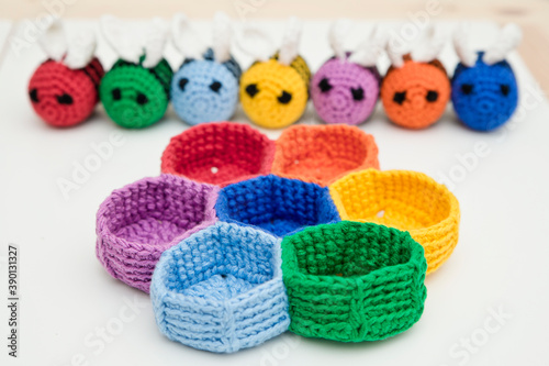 Colorful beehive with bees. Crochet safe toys for babies. Processed egg craft ideas are a bright Easter-colored rainbow-colored educational toy. Preschool game for young children. Montessori education © Birute