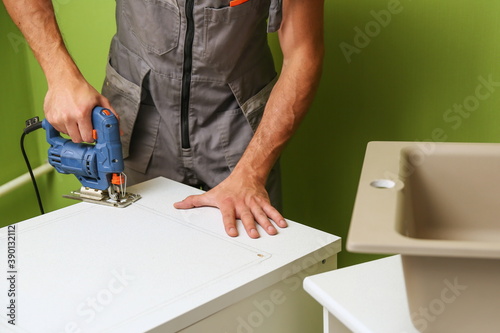 Wallpaper Mural hands of worker installs kitchen sink Torontodigital.ca