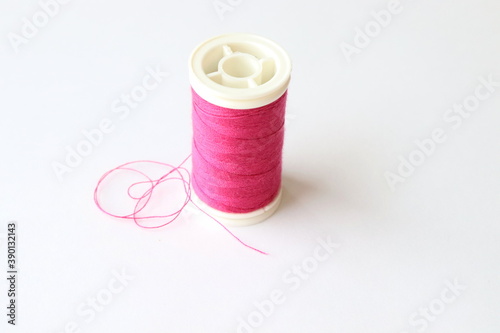  pink thread wound reel, close up.