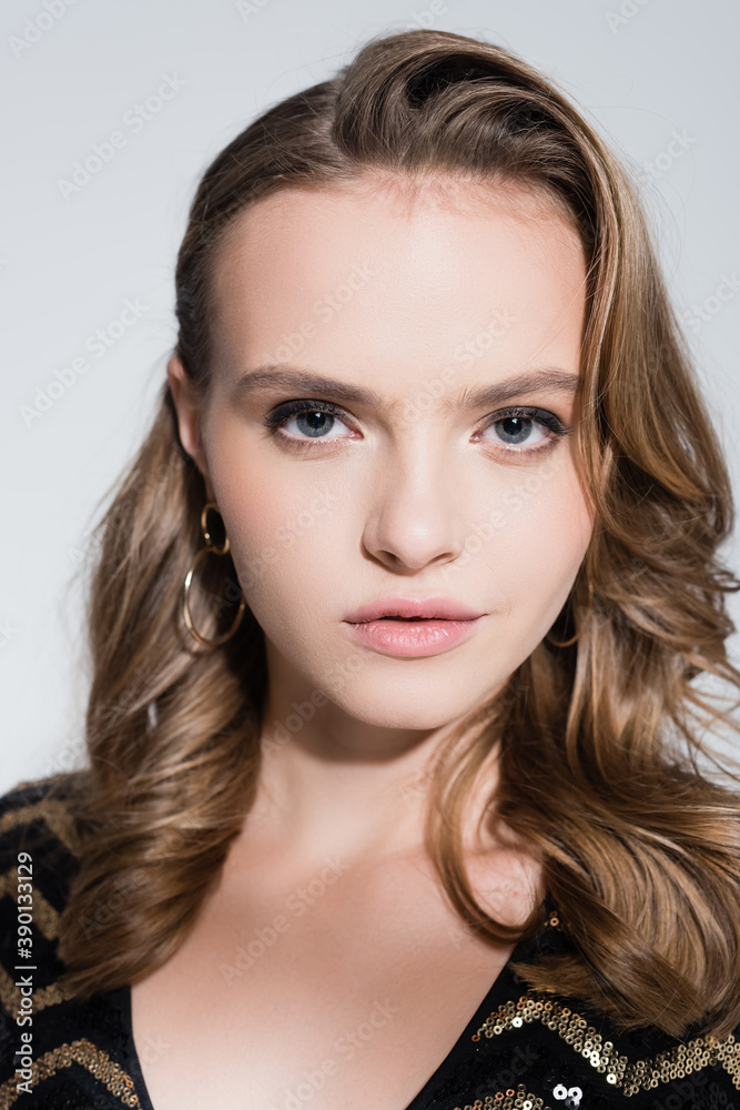 close up of serious young woman looking at camera isolated on grey close up of serious young woman looking at camera isolated on grey