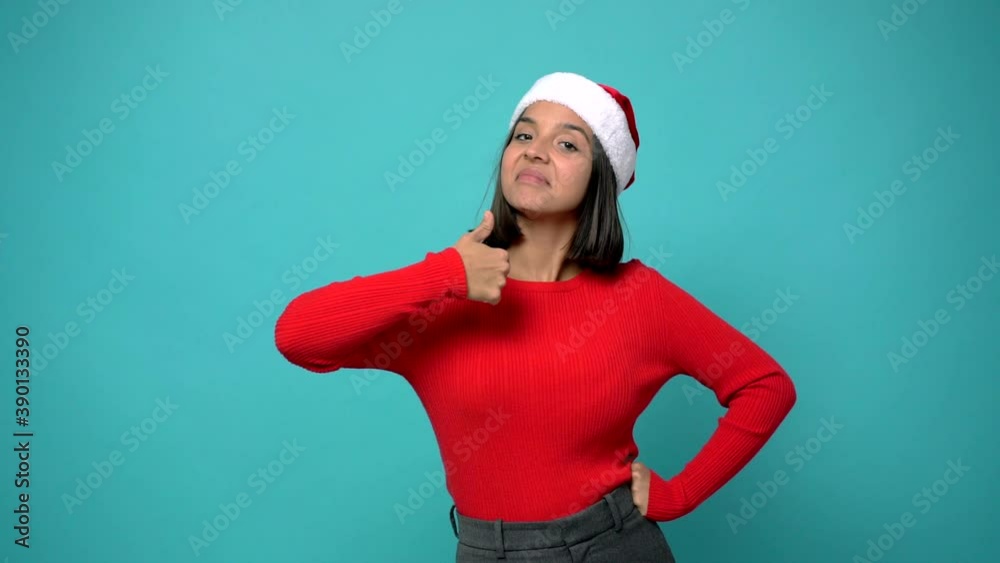 woman giving thumbs up and smiling because something good has happened in christmas holidays woman giving thumbs up and smiling because something good has happened in christmas holidays