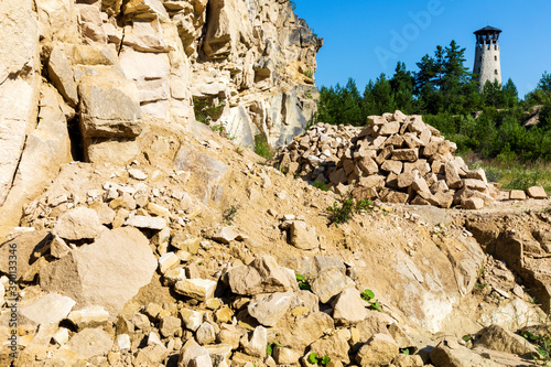 Tourist stone observation tower in limestone quarry. Tower between trees. Jozefow,  Poland, Europe. photo