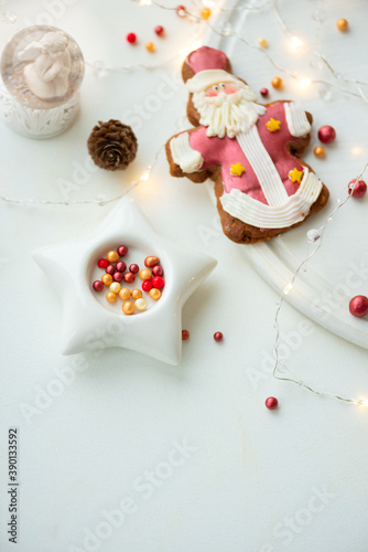 Tasty icing Christmas cookies on white table. Traditional Xmas gingerbread cookies