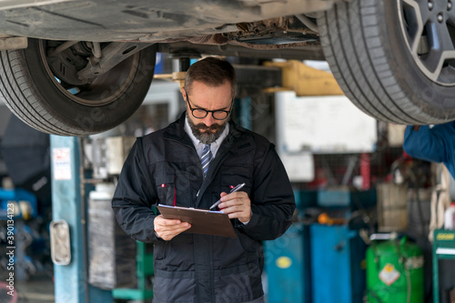 Portrait of professional staff confident working on maintenance inspection in the auto services/tires services centre	