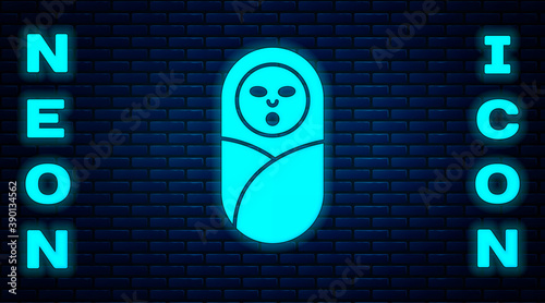 Glowing neon Newborn baby infant swaddled or swaddling icon isolated on brick wall background. Baby kid child wrapped in blanket clothes. Vector.