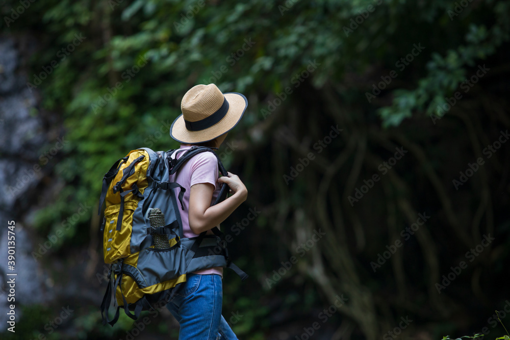 Women with backpackers enjoy waterfalls, women in nature, backpackers, nature tourism concept.