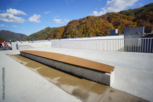 On the dam body. Blue sky and autumn mountains. Japanese landscape. Beautiful autumn landscape.