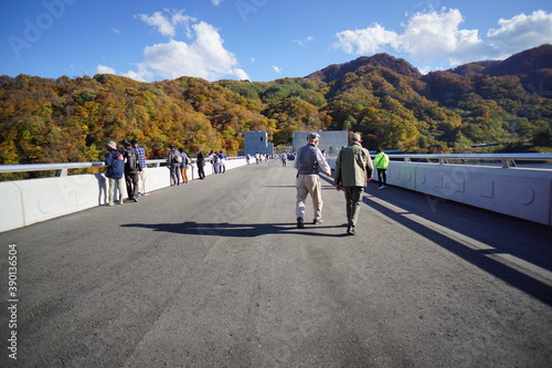 On the dam body. Blue sky and autumn mountains. Japanese landscape. Beautiful autumn landscape.