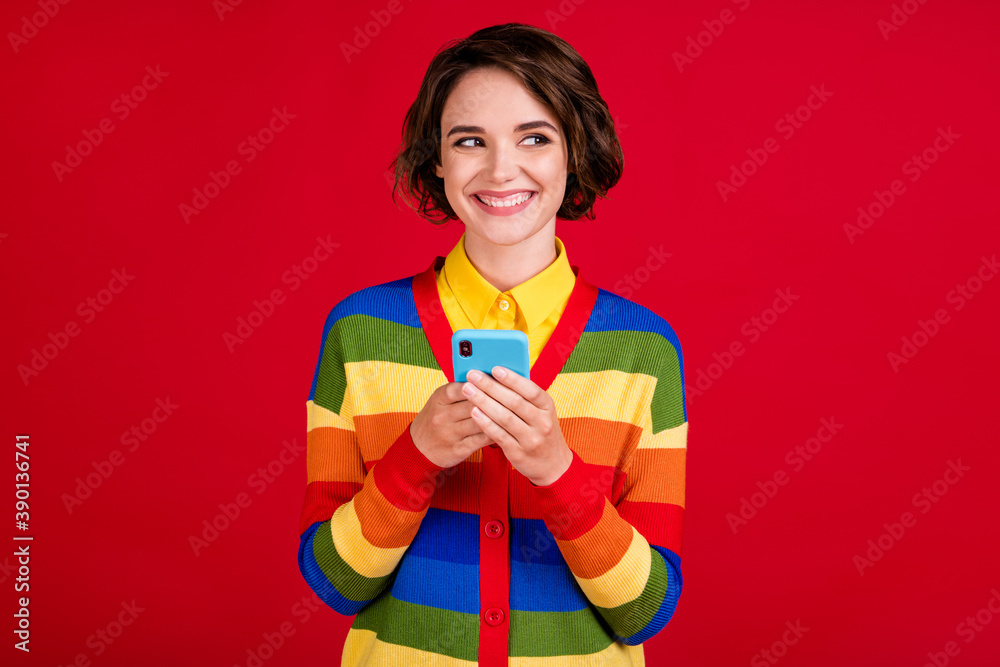 Photo of pretty funny lesbian lady hold telephone hands reading girlfriend sms overjoyed look interested side empty space wear stripes jumper cardigan isolated red color background Photo of pretty funny lesbian lady hold telephone hands reading girlfriend sms overjoyed look interested side empty space wear stripes jumper cardigan isolated red color background