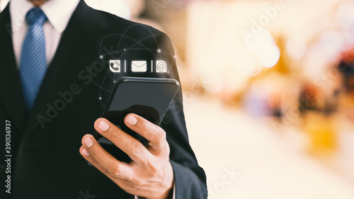 Businessman holding smartphone with icon customer support.