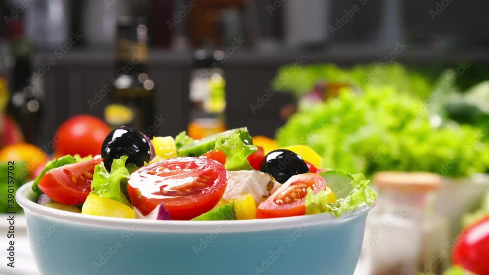 Greek salad on fork with feta cheese and olives, fresh vegetable salad served with healthy food ingredients, mediterranean cuisine