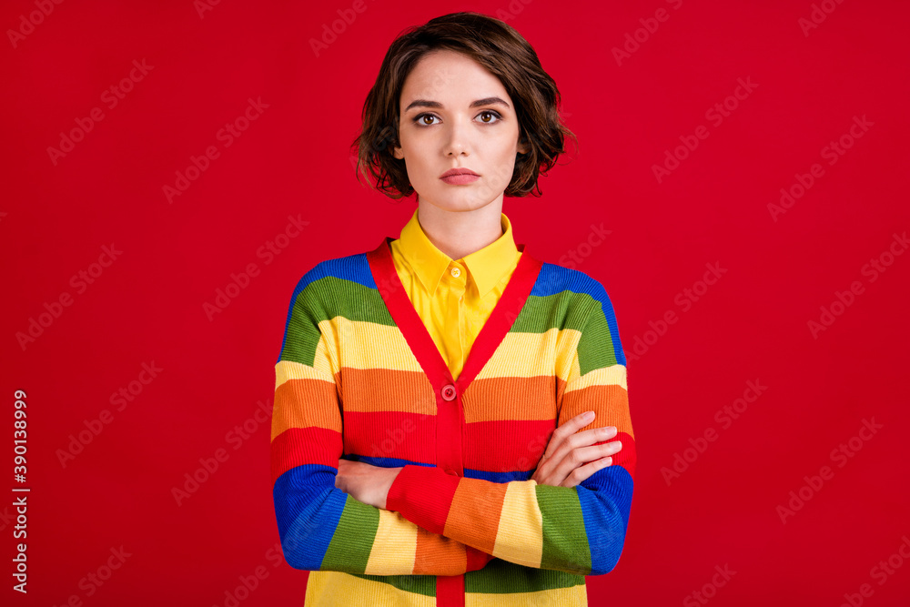 Photo of beautiful lesbian lady serious protester member proud sexual rights arms crossed against discrimination wear colorful rainbow jumper cardigan isolated bright red color background Photo of beautiful lesbian lady serious protester member proud sexual rights arms crossed against discrimination wear colorful rainbow jumper cardigan isolated bright red color background