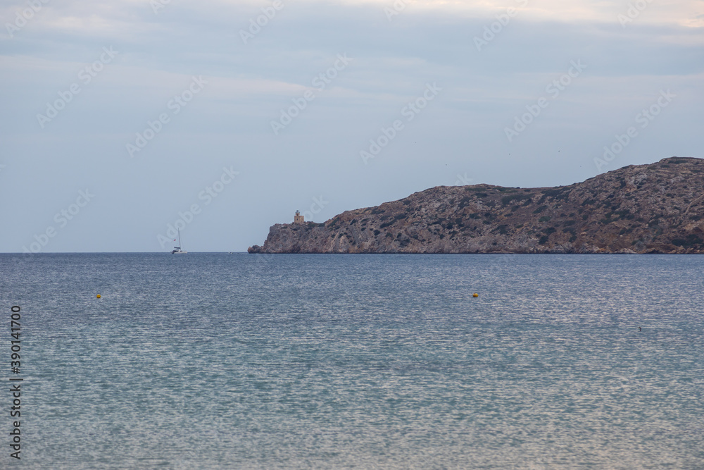 View of the lighthouse on the peninsula, Paralia Gialos, Ios Island, Greece. View of the lighthouse on the peninsula, Paralia Gialos, Ios Island, Greece.