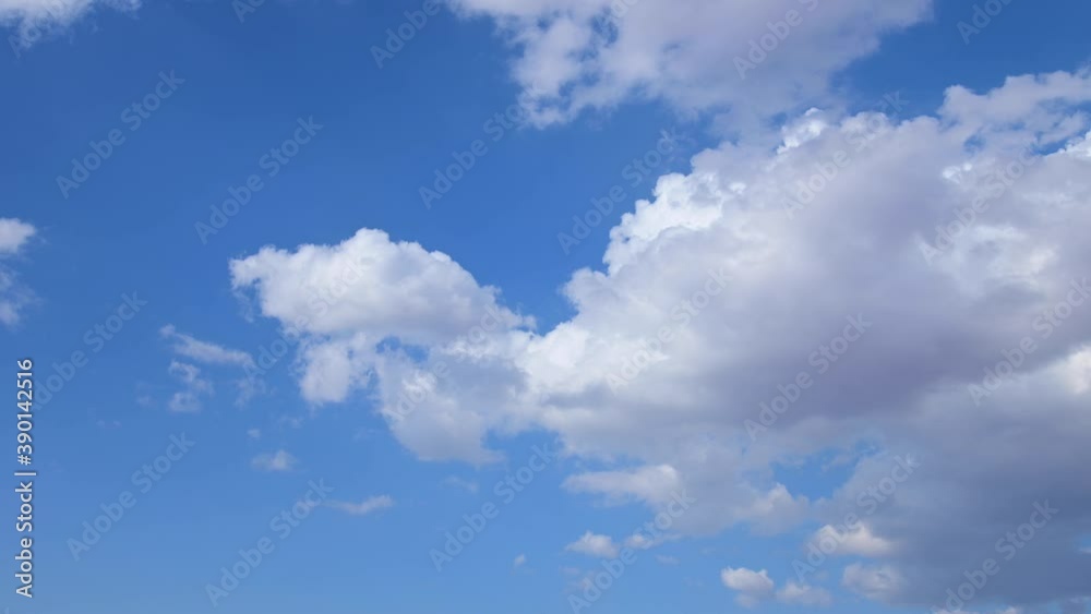 Time-lapse white fluffy clouds changing their shape against a blue sky during the day. Weather change Time-lapse white fluffy clouds changing their shape against a blue sky during the day. Weather change