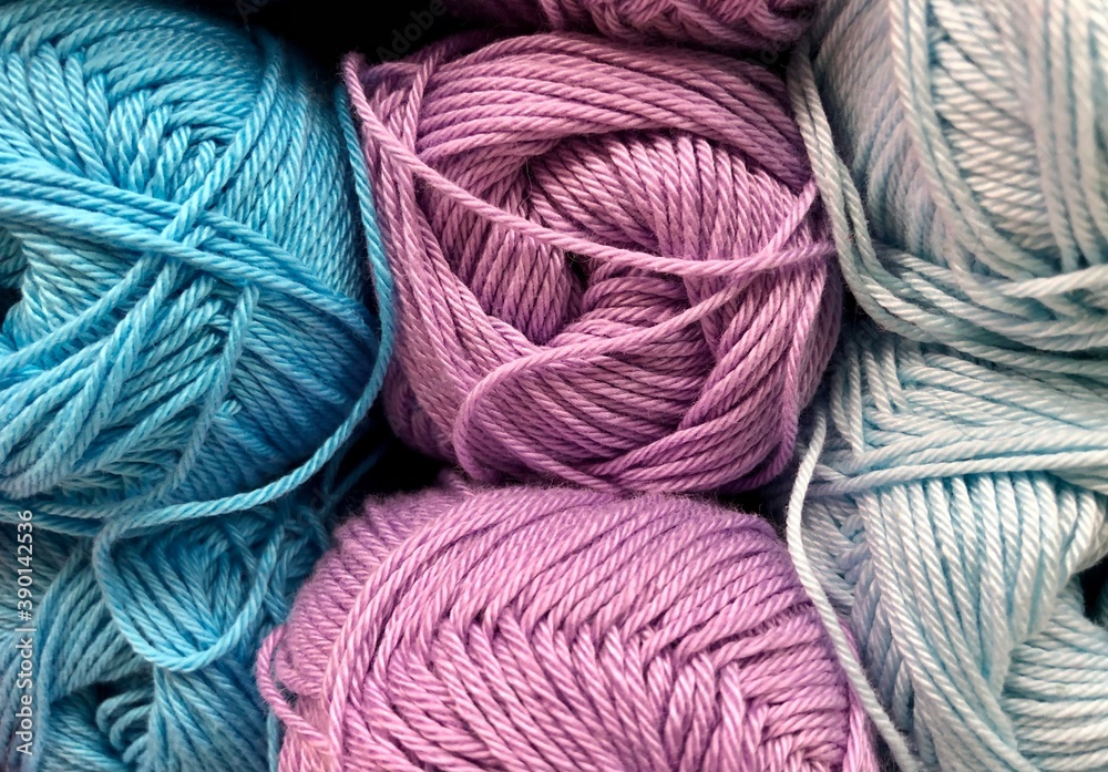 Balls of wool, multi-colored, close-up. The assortment of yarns is on display in the store. Sale of yarn for knitting. Balls of wool, multi-colored, close-up. The assortment of yarns is on display in the store. Sale of yarn for knitting.