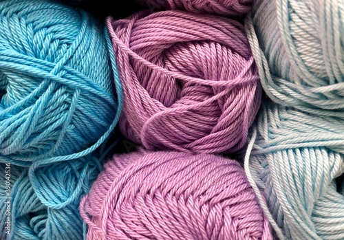 Balls of wool, multi-colored, close-up. The assortment of yarns is on display in the store. Sale of yarn for knitting.