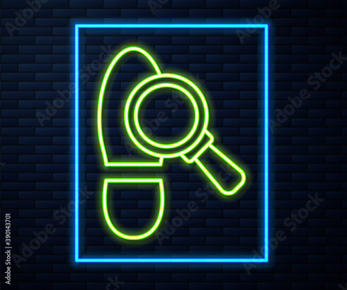 Glowing neon line Magnifying glass with footsteps icon isolated on brick wall background. Detective is investigating. To follow in the footsteps. Vector.