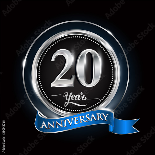 Celebrating 20th years anniversary logo. with silver ring and blue ribbon.
