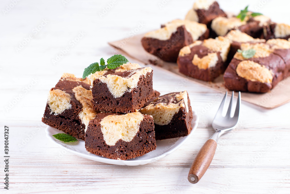 Chocolate spongy brownie cakes with cookies - Brookies in a white plate. Trend dessert