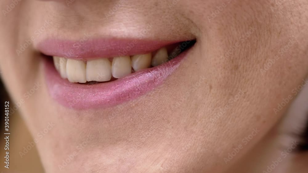 Smiling Female Mouth with Natural White Teeth and Pink Lipstick. Health Concept Smiling Female Mouth with Natural White Teeth and Pink Lipstick. Health Concept