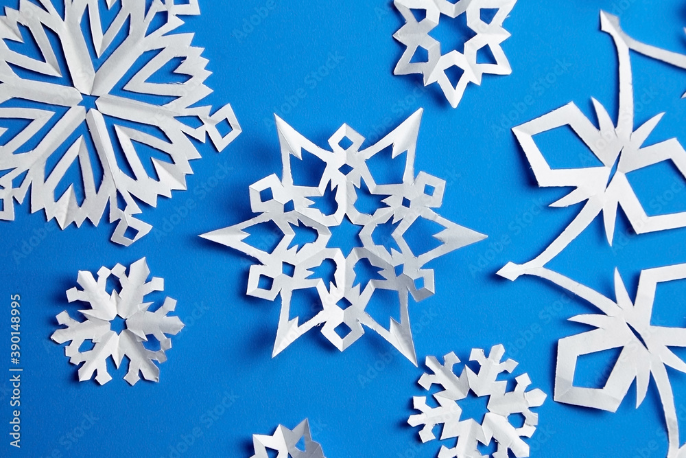 Composition with paper snowflakes on blue background Composition with paper snowflakes on blue background