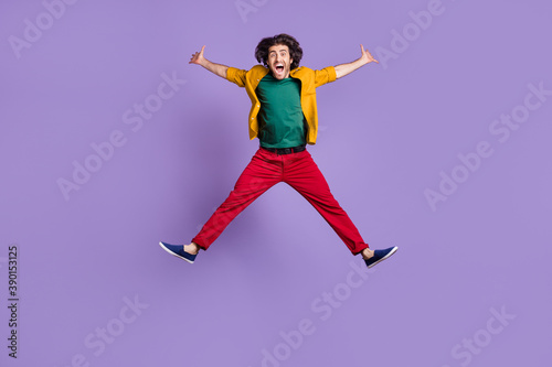 Photo portrait full body view of man spreading arms legs like star jumping up isolated on vivid purple colored background