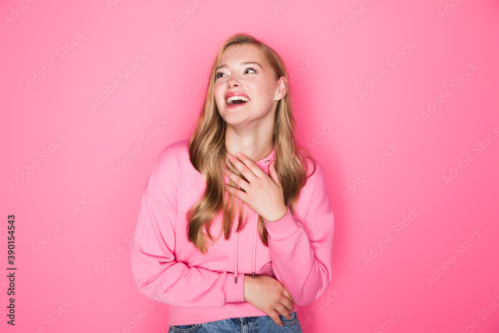 happy beautiful young woman in hoodie laughing on pink background happy beautiful young woman in hoodie laughing on pink background