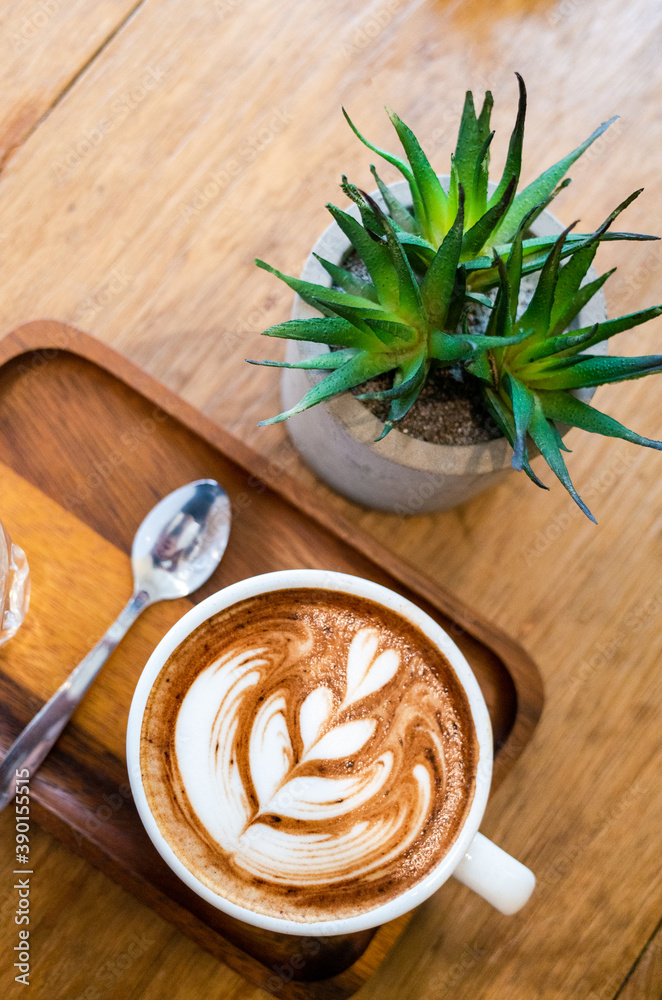 A cup of latte on wooden table A cup of latte on wooden table