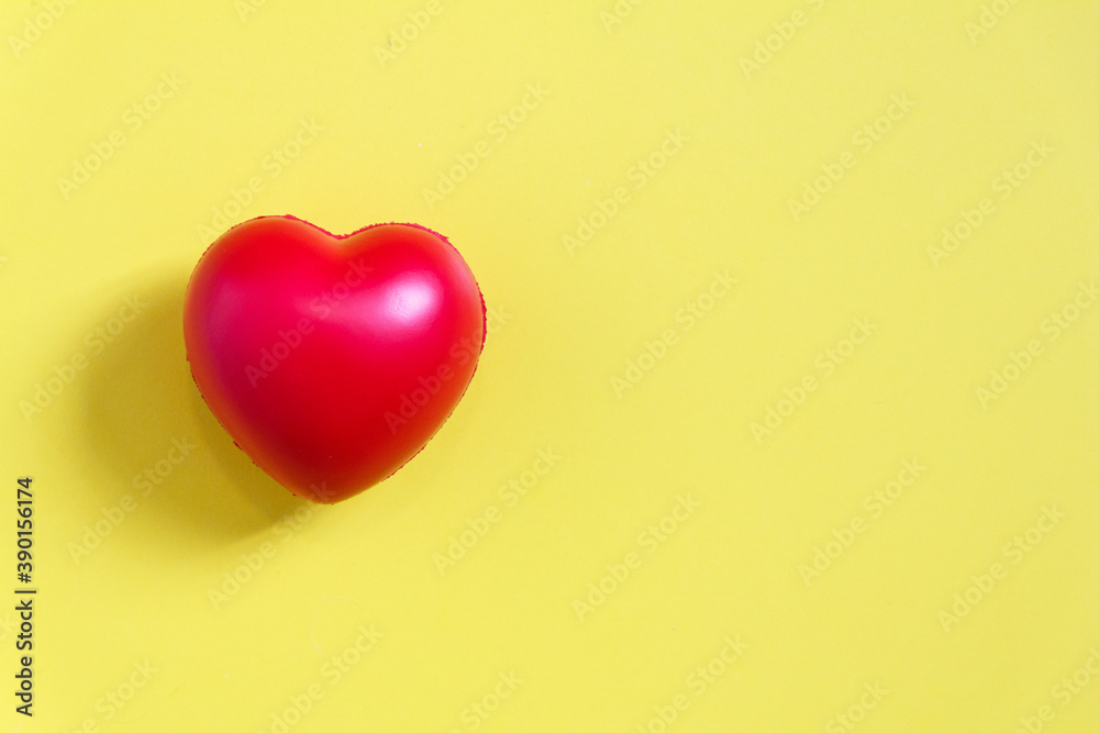 Red heart ball with yellow paper background for love concept, and wedding or Health care.