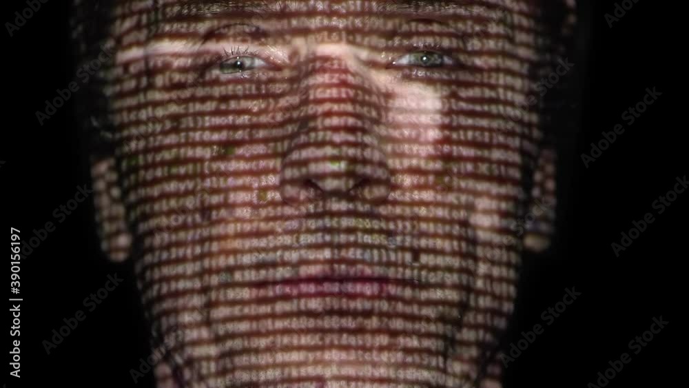 In the dark, a man's face reflects a film, clip, advertisement, video content that he is watching. Different emotions on the face. Closeup