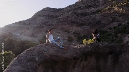 Young Couple Relaxing On Rocks In Spain