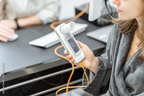 Patient holding spirometer photo