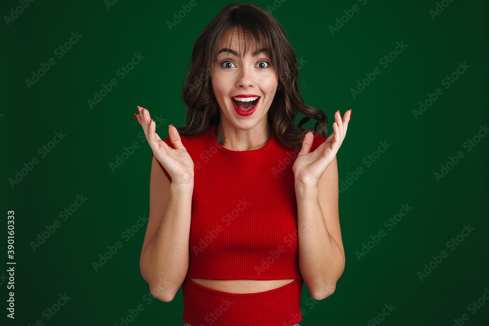 Beautiful happy brunette girl expressing surprise at camera