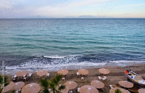 Fototapeta Naklejka Na Ścianę i Meble -  Blue sea and beach with umbrellas in Fourka Scala, Halkidiki, Greece