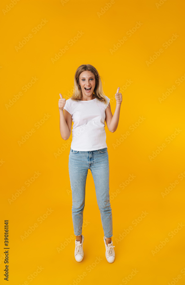 Excited beautiful girl jumping and showing thumbs up Excited beautiful girl jumping and showing thumbs up