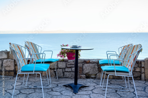 Empty restaurant terrace table in Afitos, Halkidiki, Greece © frimufilms