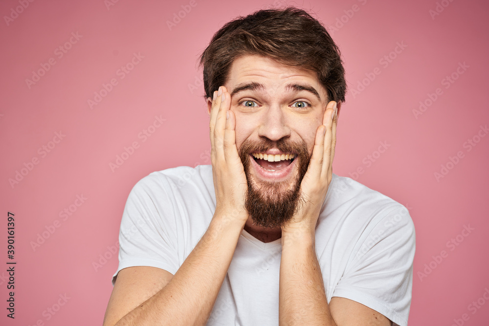 Man in white t-shirt emotions lifestyle facial expression cropped view pink background. Man in white t-shirt emotions lifestyle facial expression cropped view pink background.