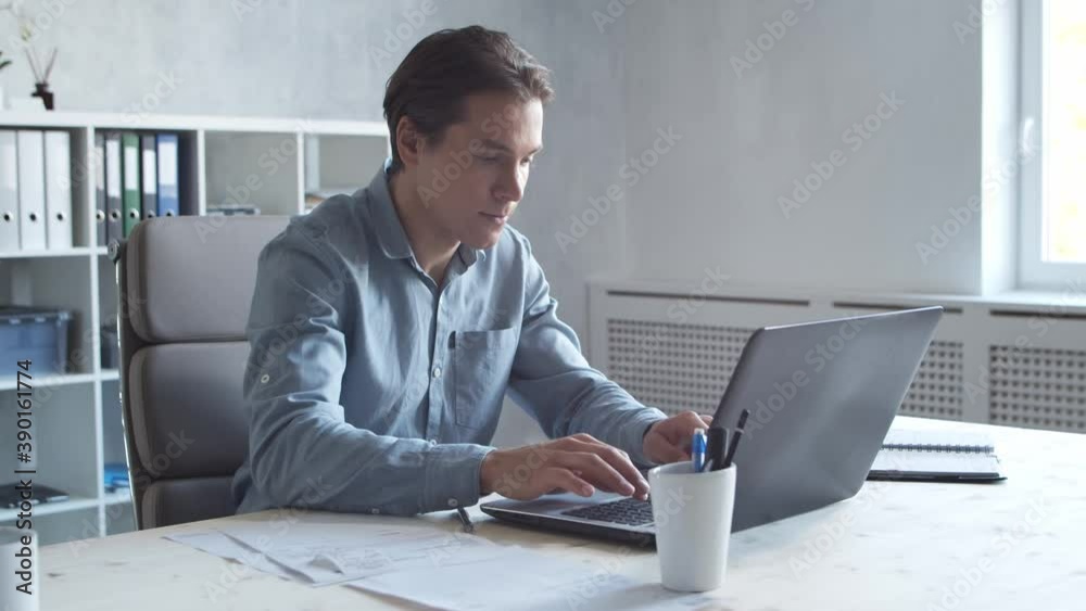 Business persons is work alone in modern office using computer technology. Workplace of young businessman. Business persons is work alone in modern office using computer technology. Workplace of young businessman.