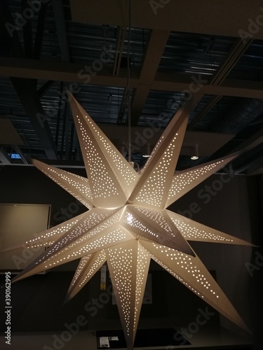Christmas lamp in the form of a white three-dimensional star