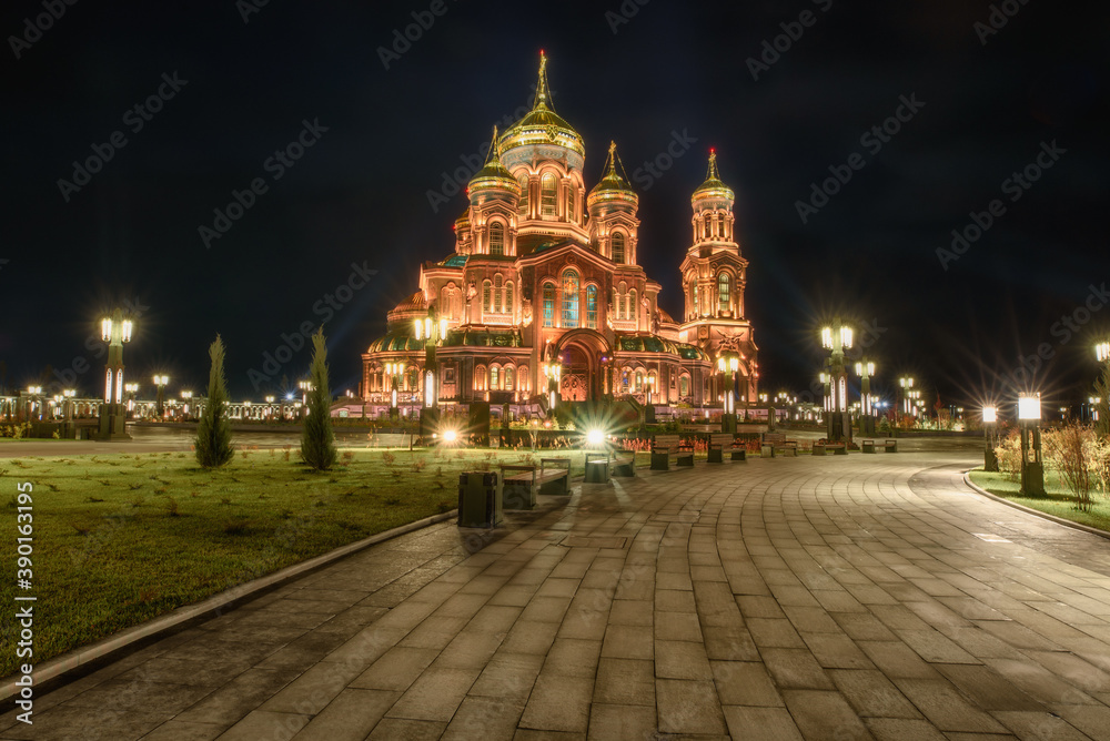Main Cathedral of the Russian Armed Forces in honor of the Resurrection of Christ with bell tower at Patriot theme park in Kubinka illuminated in gold color in the dusk.