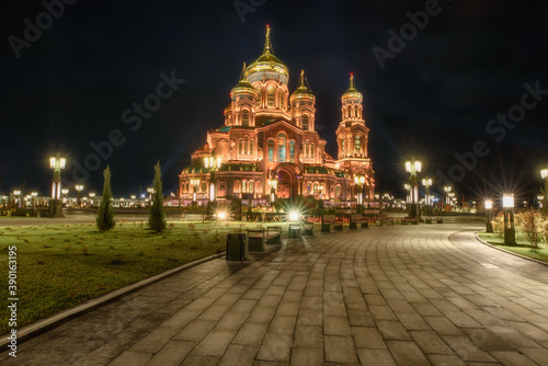 Main Cathedral of the Russian Armed Forces in honor of the Resurrection of Christ with bell tower at Patriot theme park in Kubinka illuminated in gold color in the dusk.