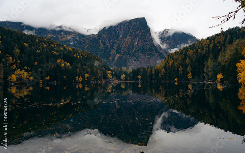 Alpine lake of Piburger See in the Otztal valley in the Austrian Tyrol during autumn, colorful trees in the Alps photo